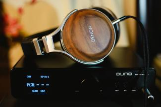 Denon headphones on amplifier by Alphacolor courtesy of Unsplash.