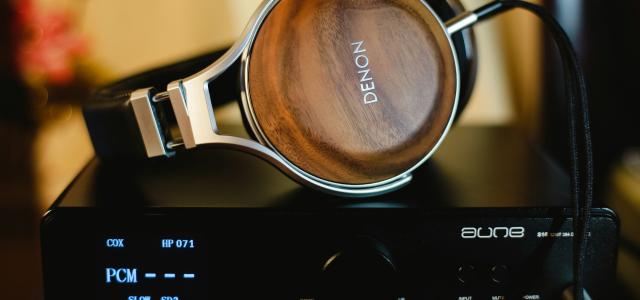 Denon headphones on amplifier by Alphacolor courtesy of Unsplash.